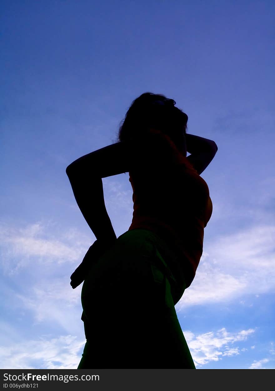 Feminine silhouette on background sky