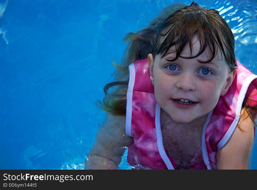 Girl Floating In Swimming Pool