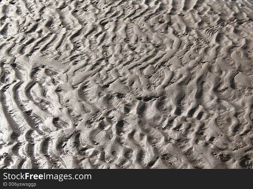 Wet sand on a beach. Wet sand on a beach