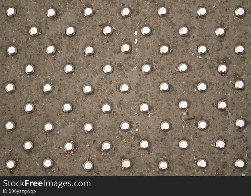 Polkadots in steel on an English pavement. Polkadots in steel on an English pavement