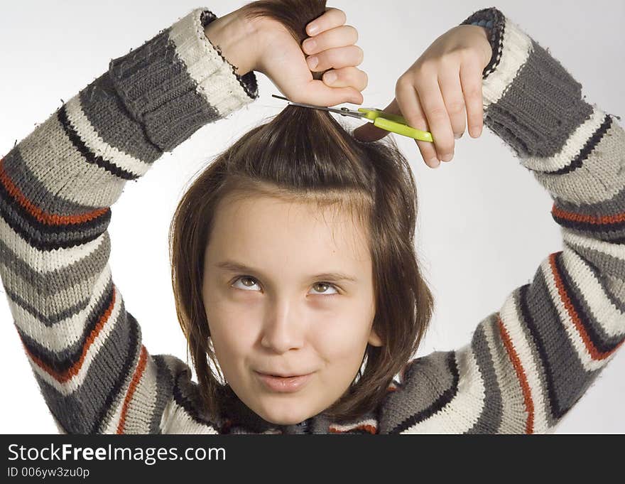 Girl cutting her hairs. Girl cutting her hairs