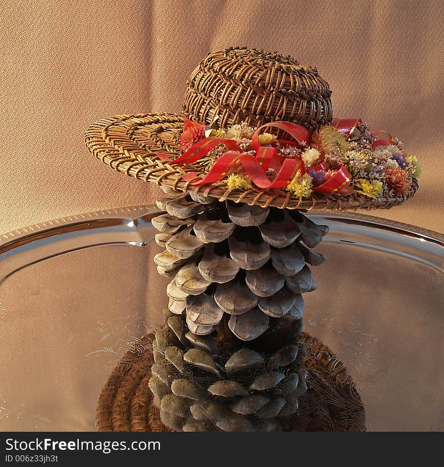 Straw hat on umbrella nut