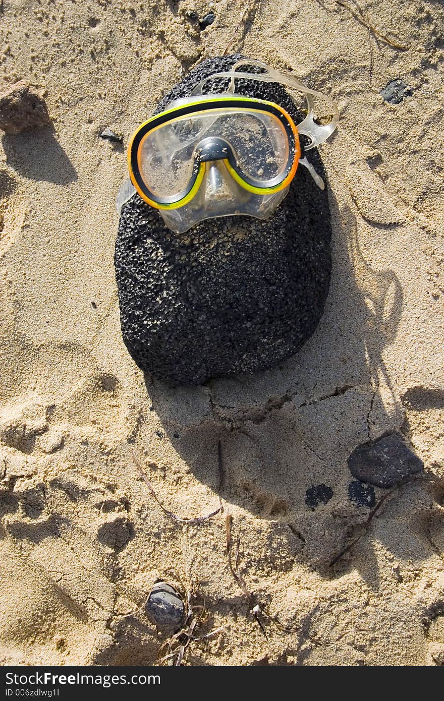 Yellow diving glasses on the rock. Yellow diving glasses on the rock