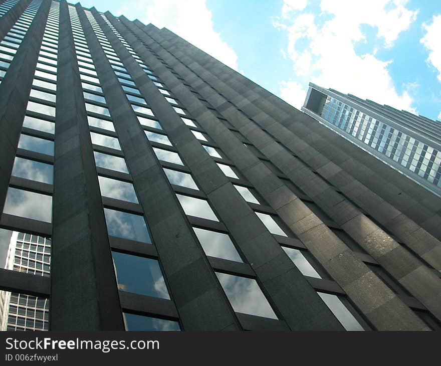 Building in Midtown Manhattan with reflection of sky. Building in Midtown Manhattan with reflection of sky.