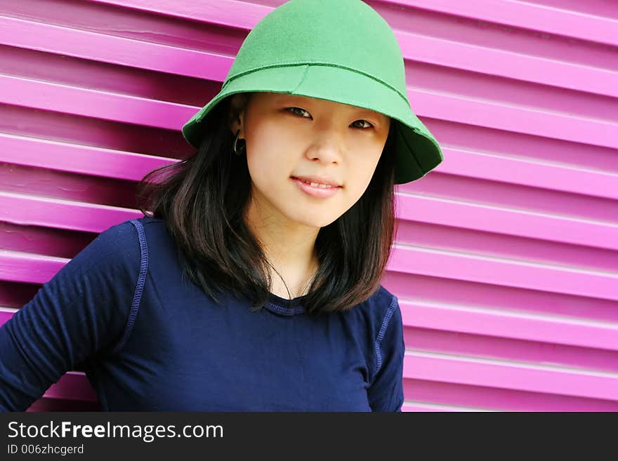 Pretty Korean woman wearing a green hat and navy blue top. Pretty Korean woman wearing a green hat and navy blue top