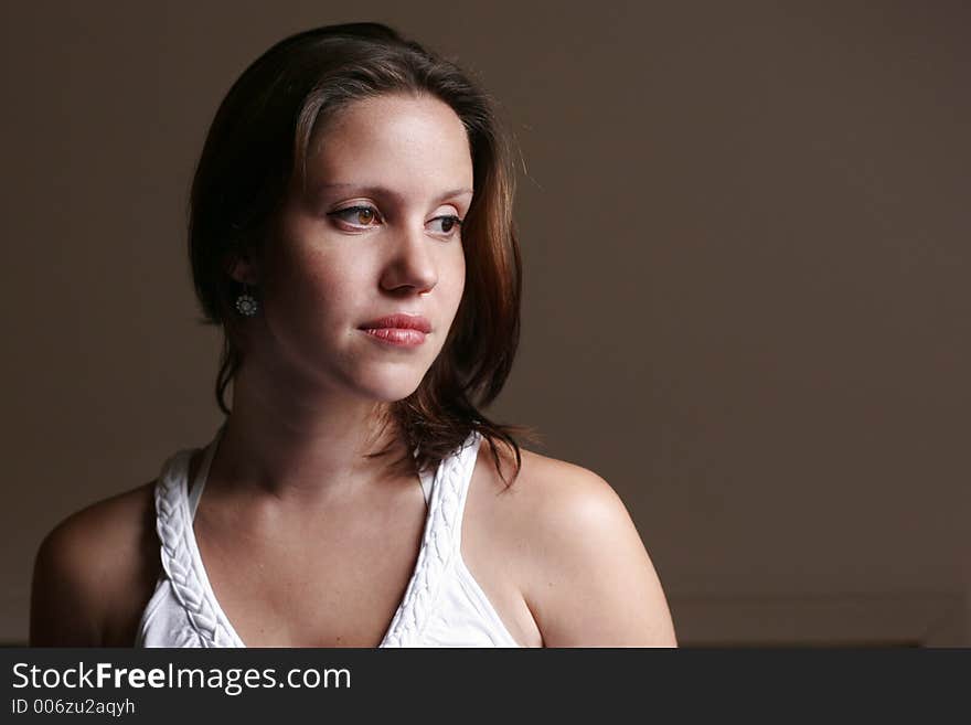 A portrait of a beautiful young woman looking beside. A portrait of a beautiful young woman looking beside.