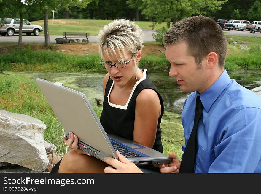 Business team working outdoors with laptop