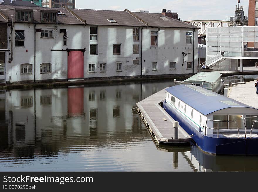 A Barge moored on the canal in Paddington Central, London. A Barge moored on the canal in Paddington Central, London.