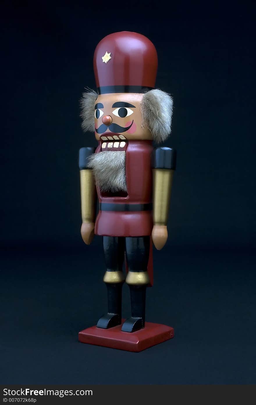 Old German nutcracker wooden soldier on a black background.