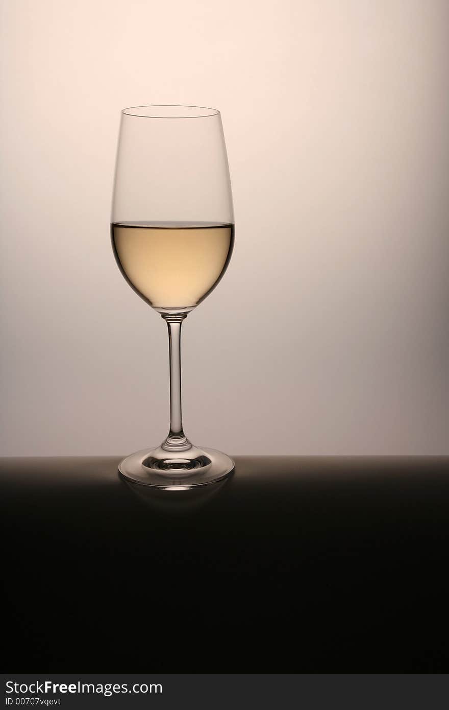 Wineglass with white wine on the table. Wineglass with white wine on the table