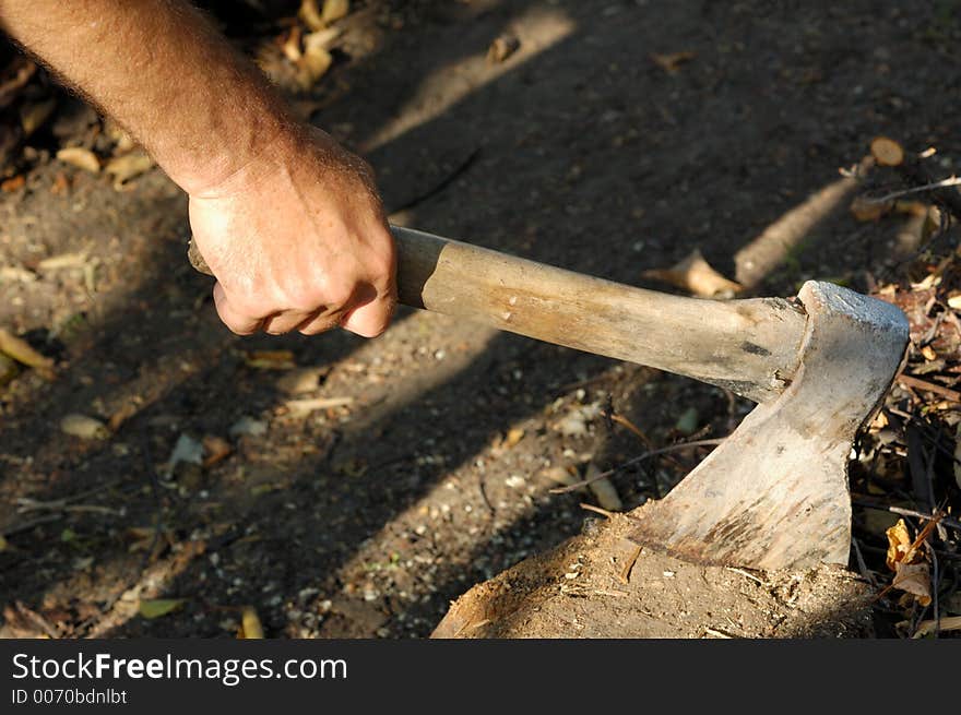 Hand with axe in stump