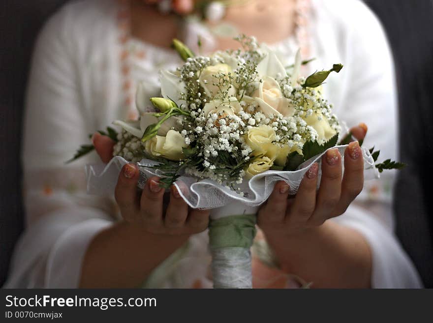 The bride holds a wedding bouquet