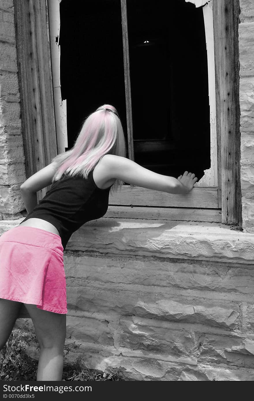 Black and white photo with pink editing peering into the broken window of an old church. Black and white photo with pink editing peering into the broken window of an old church.