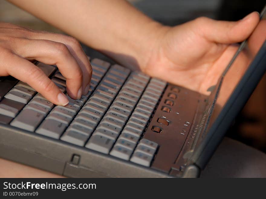 Woman typing on laptop