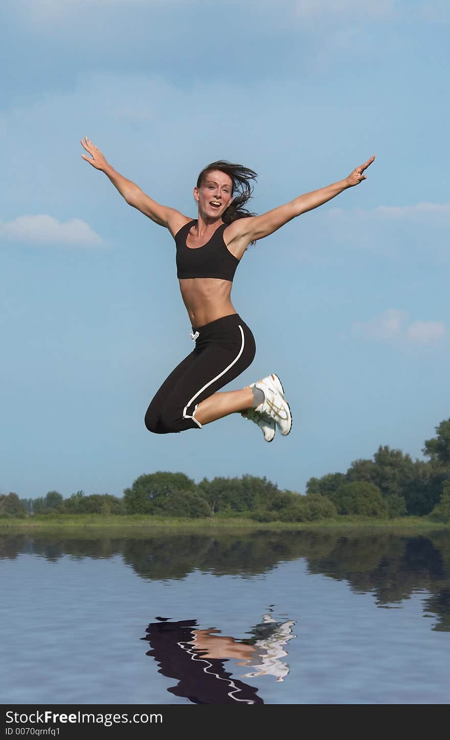 Woman jumping above water