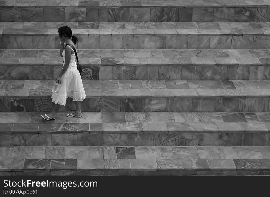 Black and white photo of walking girl