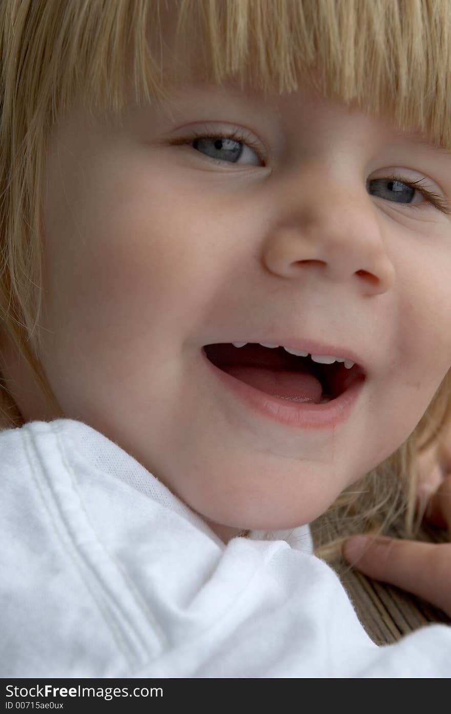 A happy little girl with a big grin