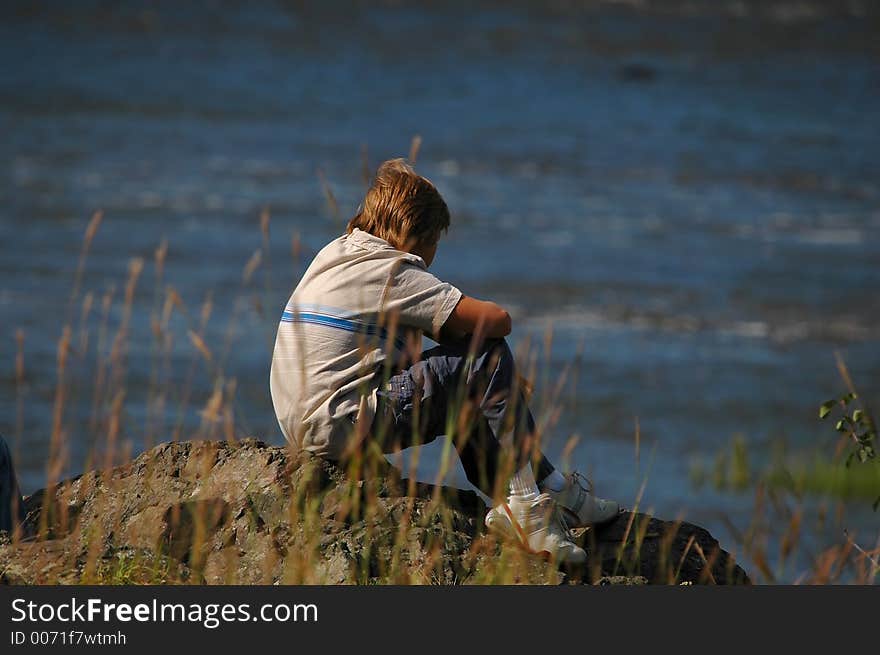 Boy looking river