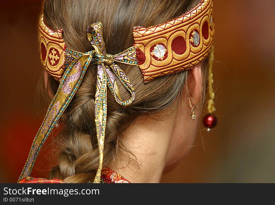 The image of Russian national ornament on a head of the woman