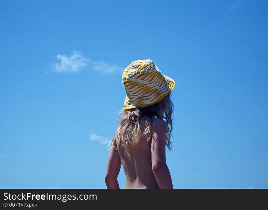 Young girl with blue sky behind