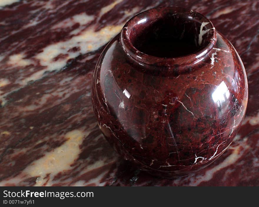 Ox red marble vase on ox red marble background