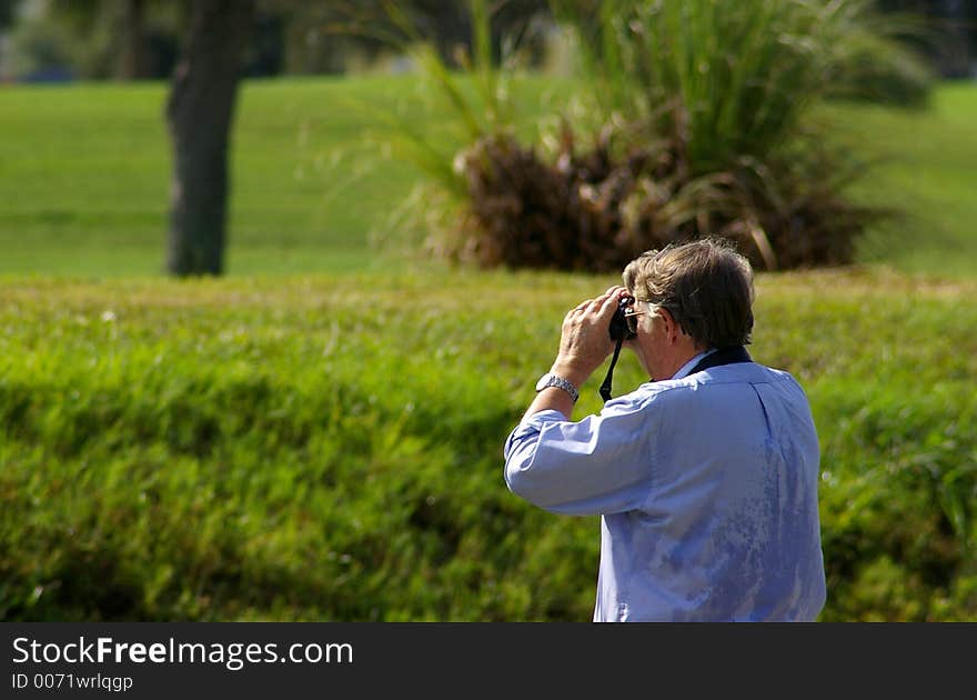 Bird Watcher looking at the birds on the Golf Course