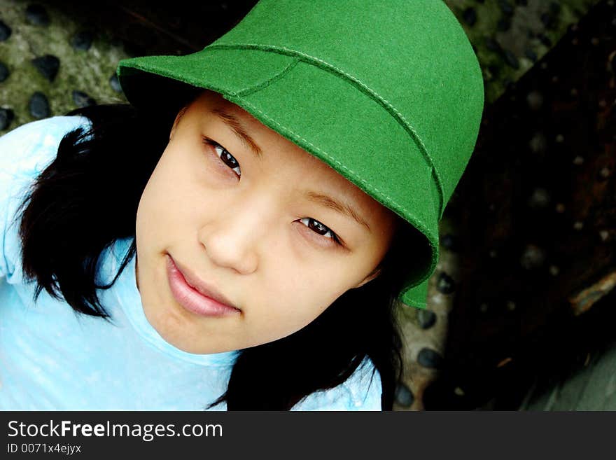 Fresh faced young Korean woman wearing a green hat. Fresh faced young Korean woman wearing a green hat