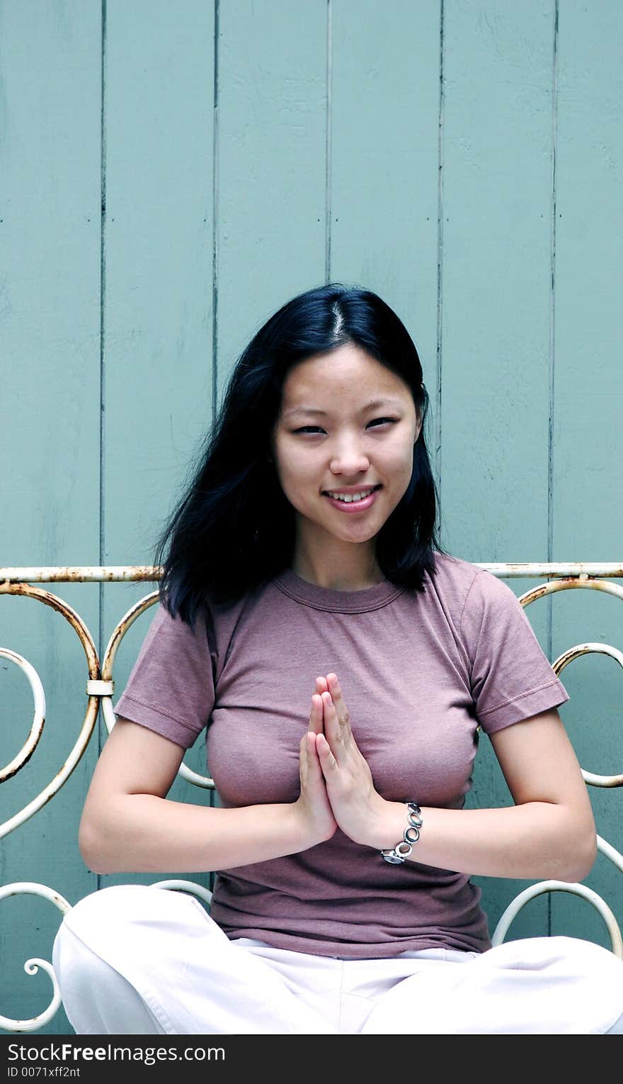 Beautiful young Korean woman sitting on a bench. Beautiful young Korean woman sitting on a bench