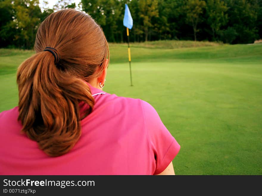 Lining up her putt. Lining up her putt