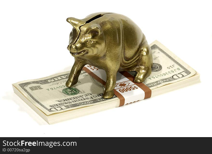 Brass Piggy Bank on a Stack of Money. Brass Piggy Bank on a Stack of Money