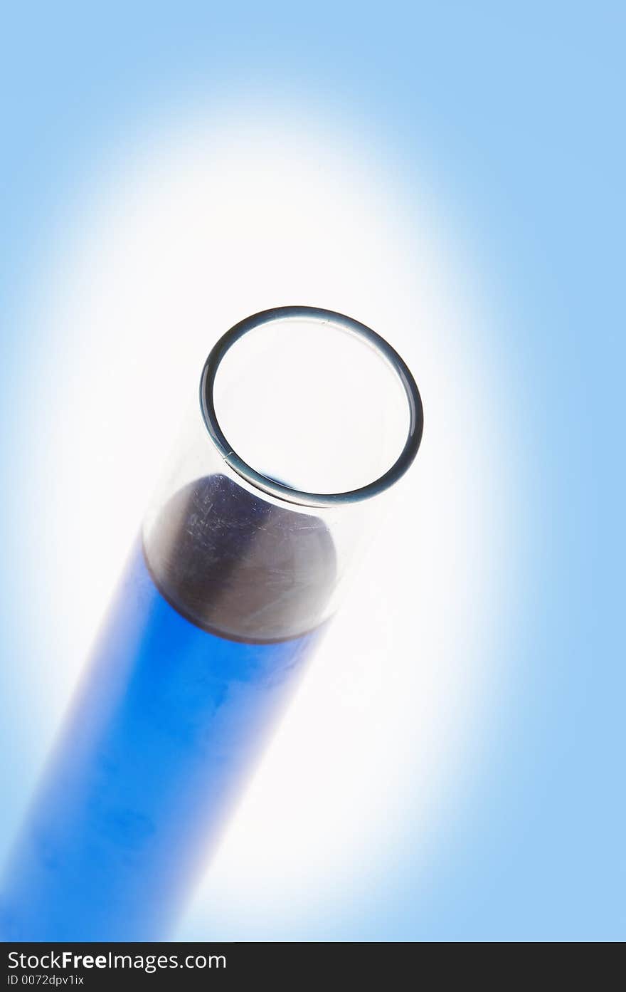 One test tube filled with blue liquid in a white shine on blue background. One test tube filled with blue liquid in a white shine on blue background