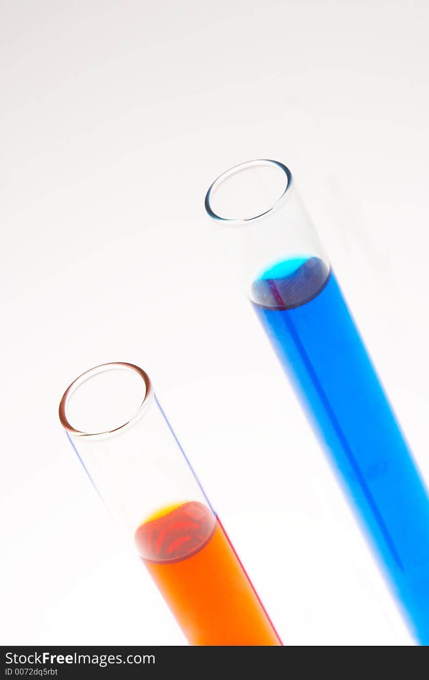 Two test tubes one with red and one with blue liquid filled on white background. Two test tubes one with red and one with blue liquid filled on white background