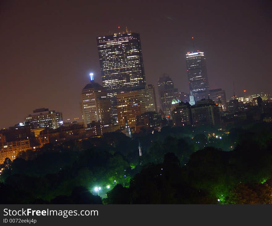 Night shot of the boston skyline, from park street to the prudential center. the trees along the bottom are the boston common. Night shot of the boston skyline, from park street to the prudential center. the trees along the bottom are the boston common