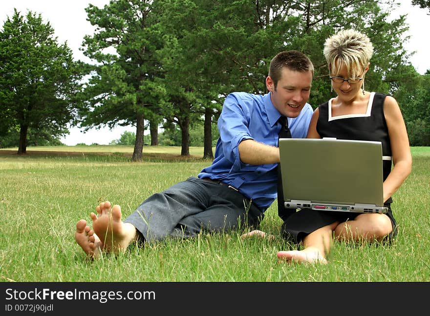 Business team working outdoors with laptop