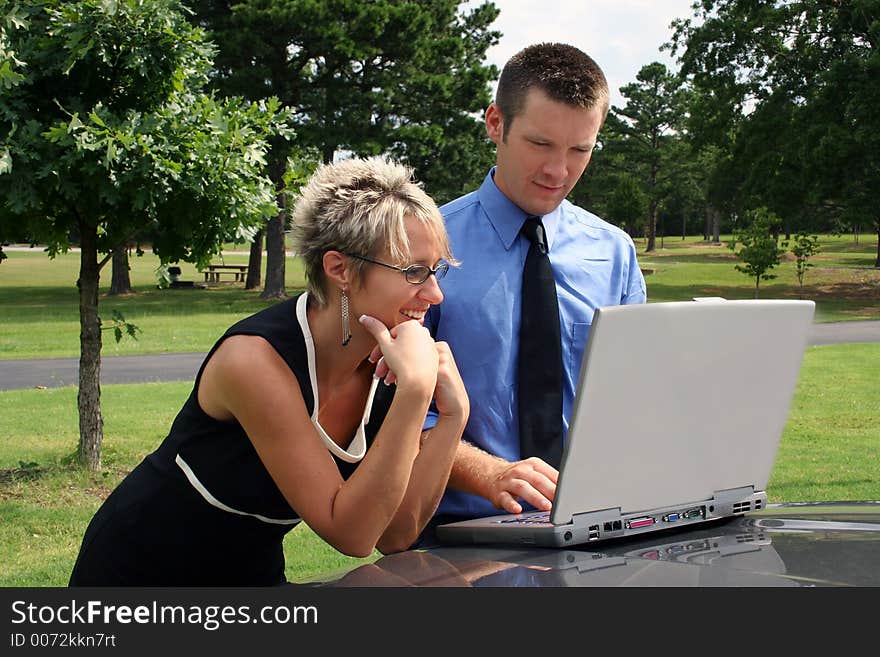 Business team working outdoors with laptop