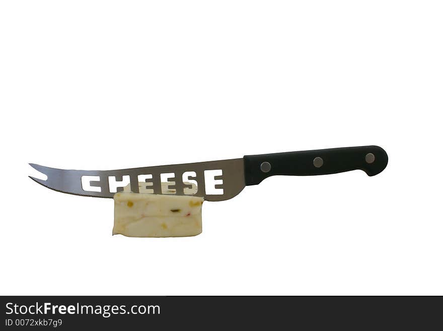 A chunk of white cheese with a cheese knife stuck in it against a white background