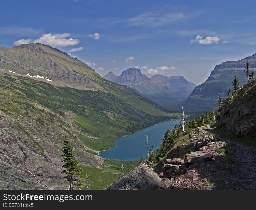 This image of the Gunsight Lake, mountains and the trail was taken on a recent hike in Glacier National Park. This image of the Gunsight Lake, mountains and the trail was taken on a recent hike in Glacier National Park.