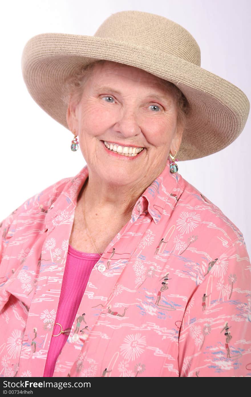 Senior women in a sun hat dressed in beach attire. Senior women in a sun hat dressed in beach attire