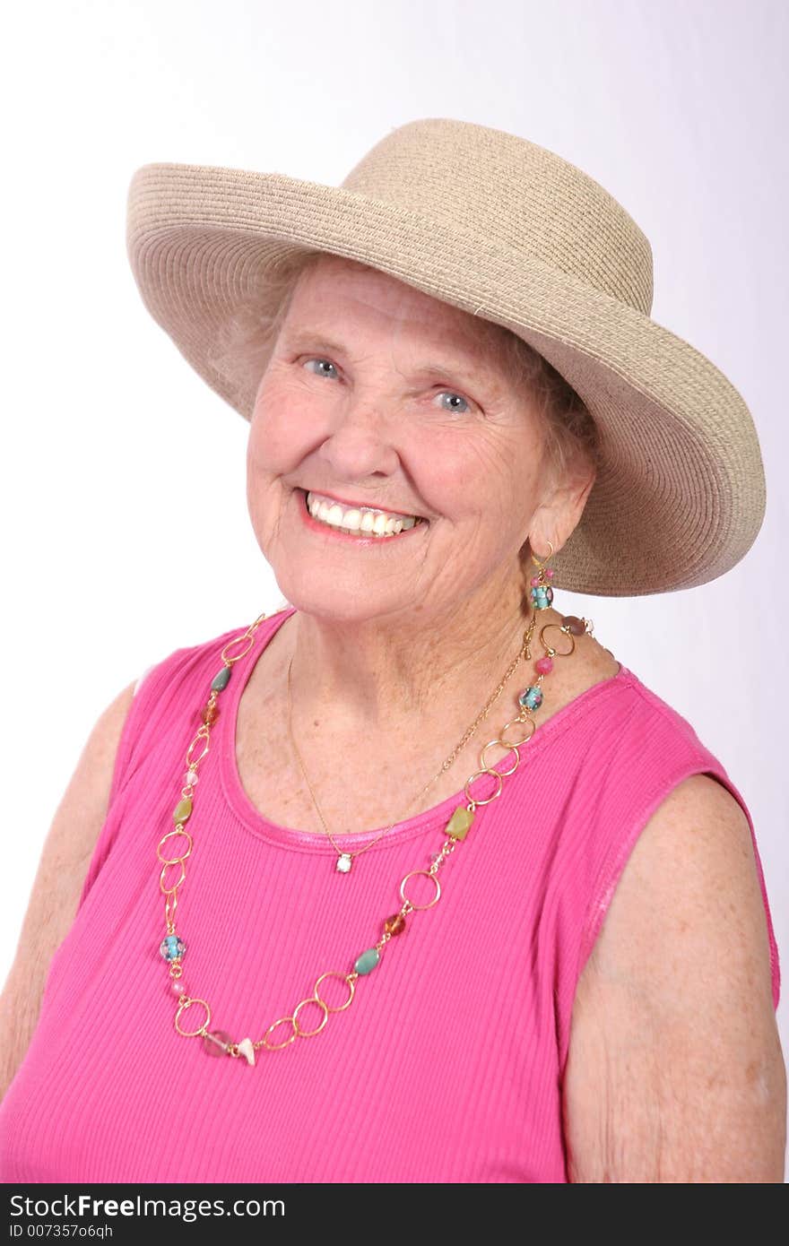 Smiling senior woman in a sun hat. Smiling senior woman in a sun hat