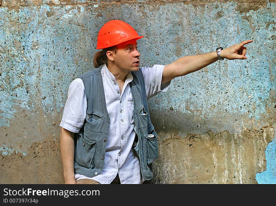 The main engineer on a background of an old wall.
The head in a red helmet a hand is lifted. The main engineer on a background of an old wall.
The head in a red helmet a hand is lifted