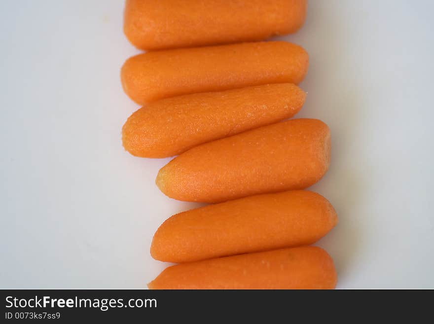 Carrots placed in a row. Carrots placed in a row.