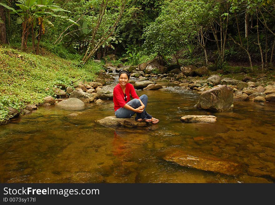 Relaxation! Girl with feet in stream.