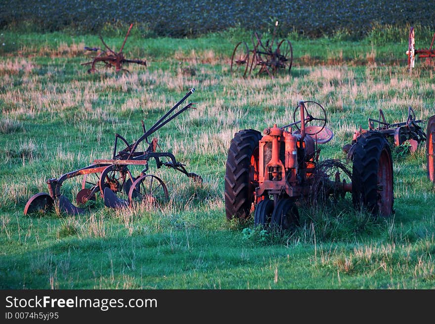 Antique tractors and farm equipment left to rust in a pasture in Iowa. Antique tractors and farm equipment left to rust in a pasture in Iowa.