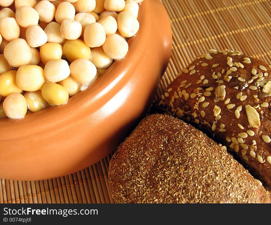 bread and pot with peas on the rug. bread and pot with peas on the rug