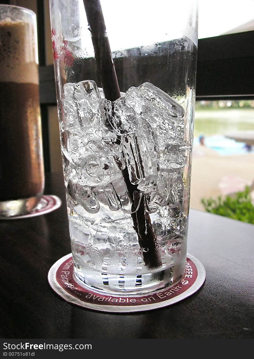 Ice water and coffee on dark table