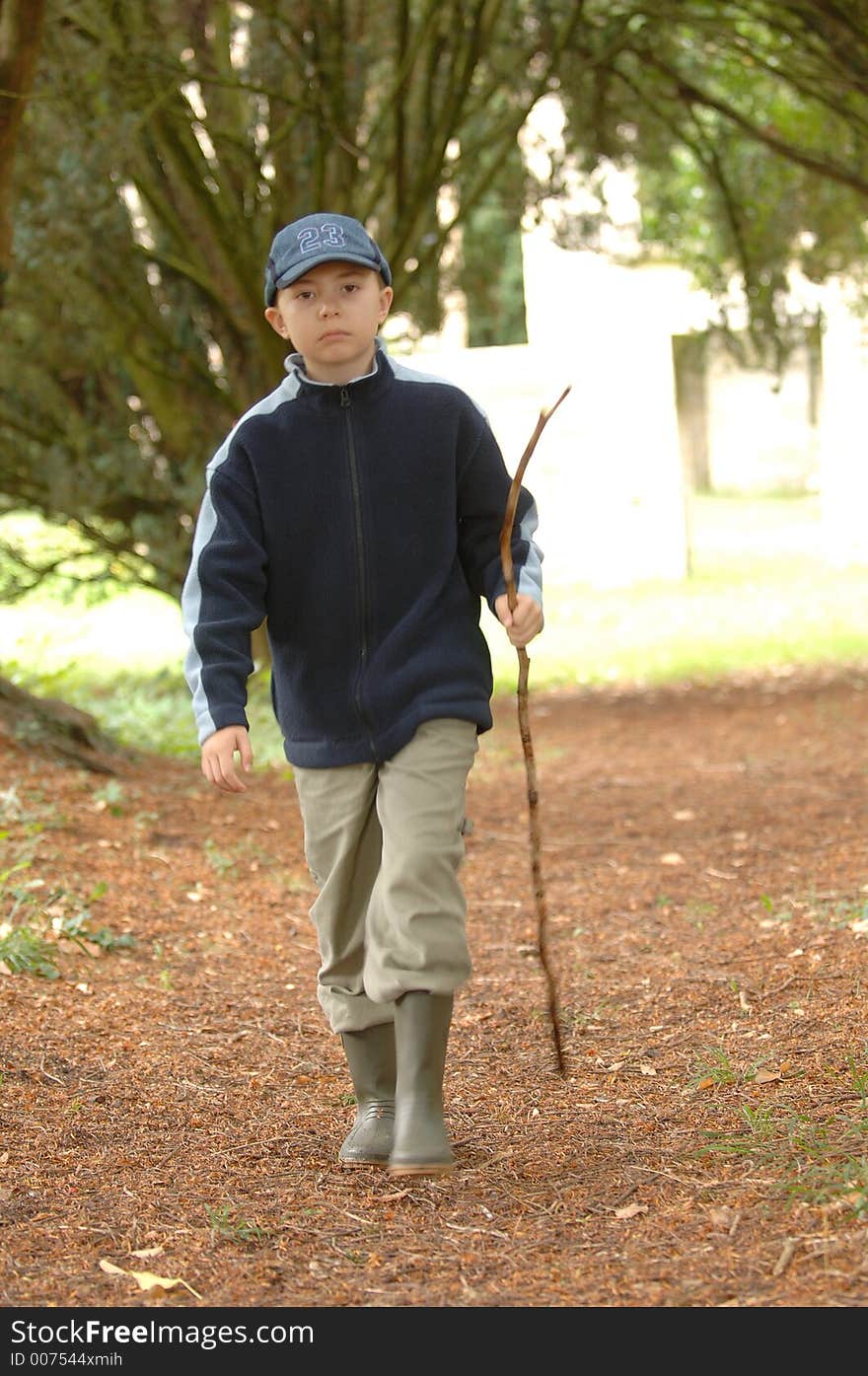 A boy walking in the park. A boy walking in the park