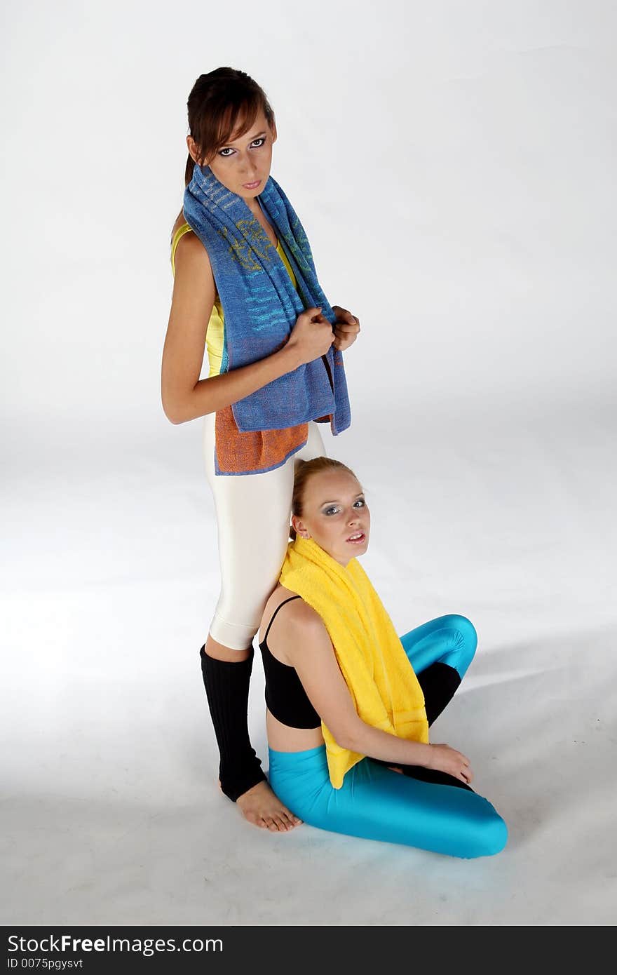 Two females with towels after fitness exercises. Two females with towels after fitness exercises
