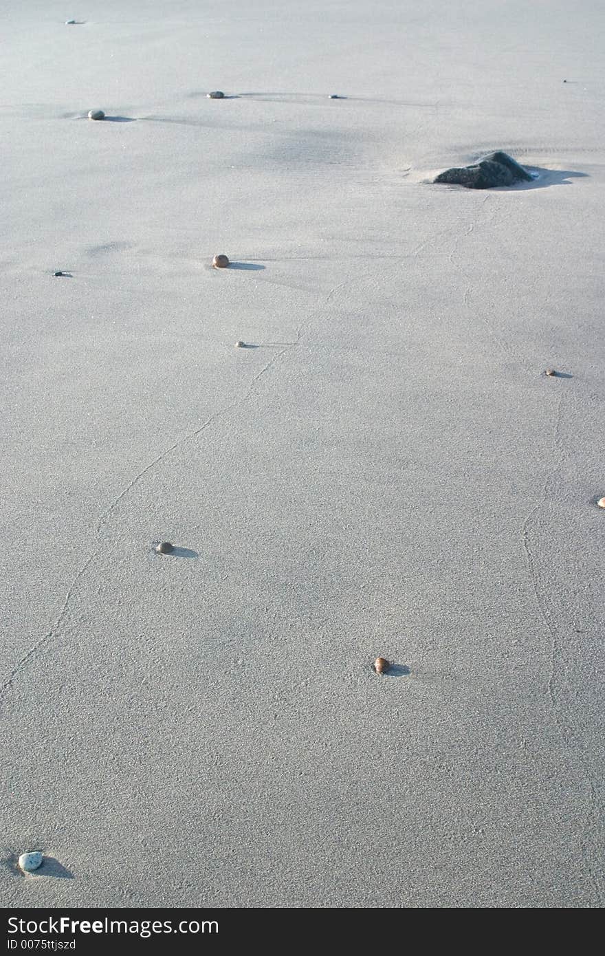 Stones in the sand at the beach. Stones in the sand at the beach