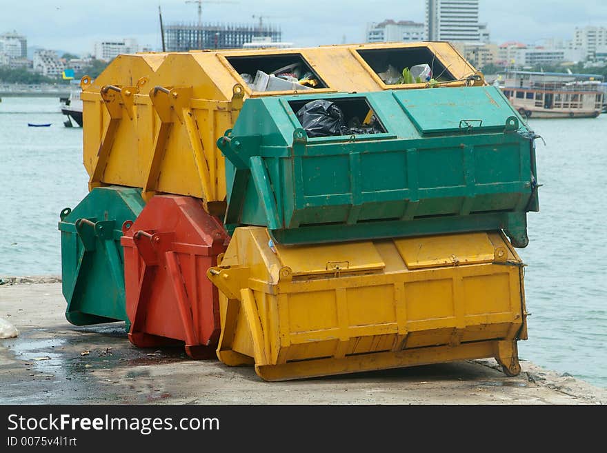 Six garbage containers, yellow, green and red.