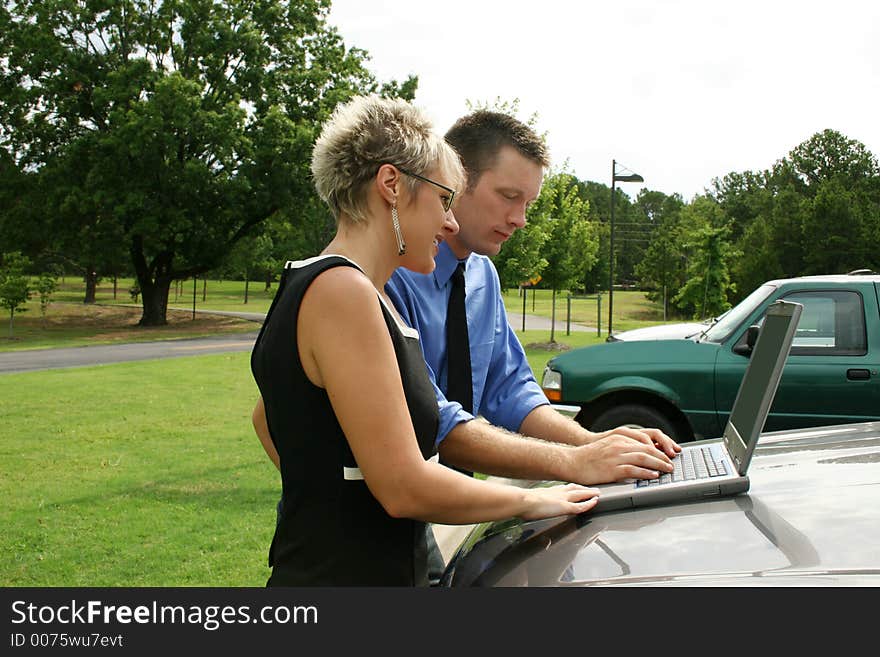 Business team working outdoors with laptop